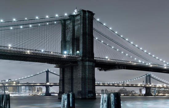 Brooklyn Bridge, one of the oldest suspension bridges in the United States. Completed in 1883, it connects the New York City boroughs of Manhattan and Brooklyn by spanning the East River, in the background Manhattan Bridge, New York City