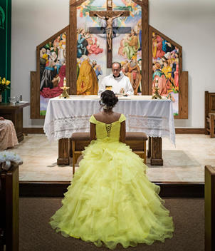 Hispanic girl celebrating quinceanera in Catholic church