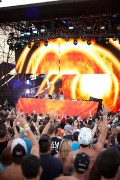 A crowd enjoying an artist at an electronic music festival\'