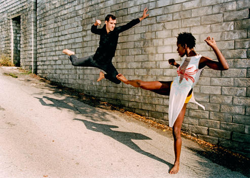 Dancers In Faux Combat On An Inclined Street.