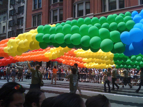 Gay Pride Parade, people holding rainbow colored balloons