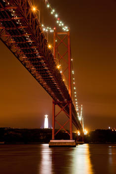 Europe, Portugal, Lisbon, View of suspension bridge with river Tagus at night