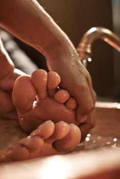 salon , foot massage in a basin with running water