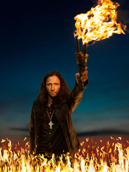 Portrait Of A Man Holding A Flaming Torch During A Magic Performance