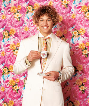 Fashion Model Sipping Tea Against Funky Floral Background