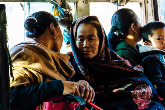 Nepalese women converse on the bus down from the mountain villages in the foothills of the Himalayas to Pokhara, Nepal.