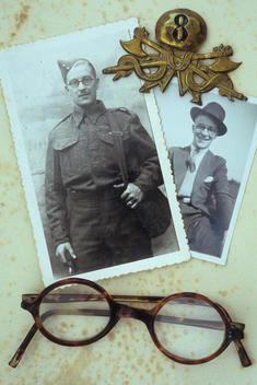 Vintage black and white photos of man in World War 2 army uniform and in civilian clothes lying with his spectacles and 8th Army badge