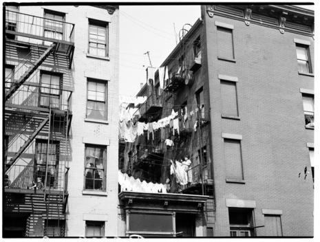 View Of Clothes Hanging On The Clothesline Between Two Tenement Buildings.