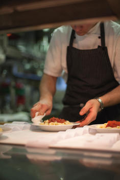a chef preparing a plate in the kitchen at the restaurant on top of Weissfluhgipfel on Parsenn mountain