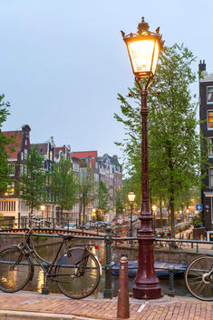 Lamp post on the Herengracht at the intersection with the Brouwersgracht at dusk, Amsterdam, North Holland, Netherlands