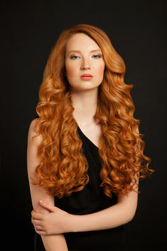Young Woman with shiny curly red hair