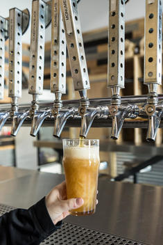 A woman pours a beer at Coachella Valley Brewing Company, near Palm Springs in Thousand Palms, California.