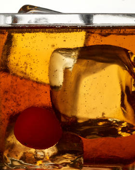 Detail of a bourbon on ice with a cherry