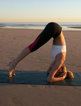 Young blonde woman doig yoga at the beach.(5of10)