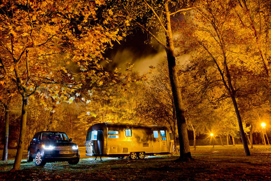 Range Rover and Airstream camping at night