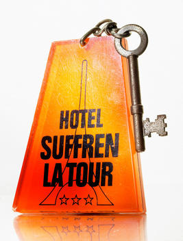 Orange plastic hotel key fob and distressed metal key