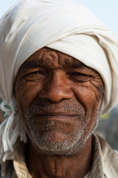 portrait of an old Indian man wearing turban and smiling