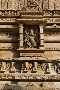ancient stone carved Ganesh statue on Hindu temple wall