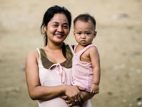 A local mother and child along the abandoned railroad tracks next to Empowering Youth in Cambodia\'s Lakeside School in an impoverished neighborhood of Phnom Penh, Cambodia.