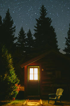 Tiny cabin in the Adirondack mountains under a starry sky.