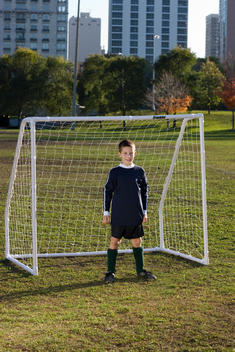 A Young Boy Protects His Goal While Playing Soccer In A Chicago Park.
