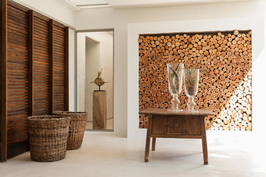 Wood logs in wall and table in modern foyer