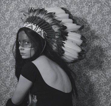 Young woman in native american headgear