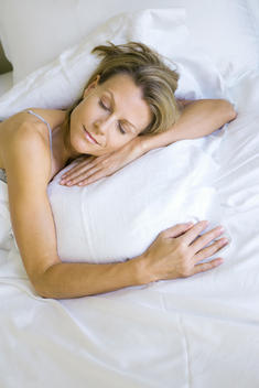 Woman sleeping on comfortable pillow, high angle view