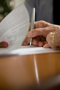 Close up of woman hands signing documents
