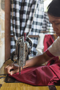 seamstress working with fabric and sewing machine at Tunjung Mas store