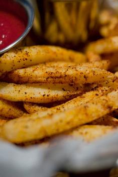 Spicy Hasrissa French Fries With Ketchup. Close-Up Food Photography.