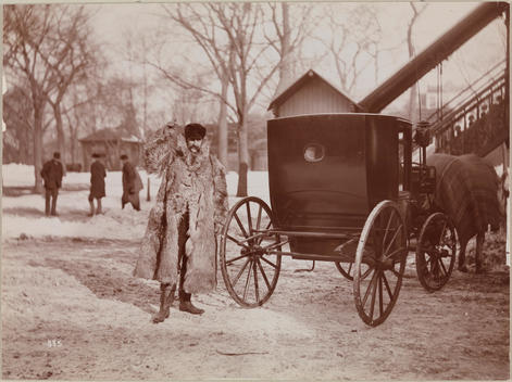 A Cab Driver At The Back Of His Carriage 'El' Staircase Is In The Background, As Are A Few Men, In The Distance, Driver Is Wearing A Full-Length Fur Coat And Waving To The Photographer.