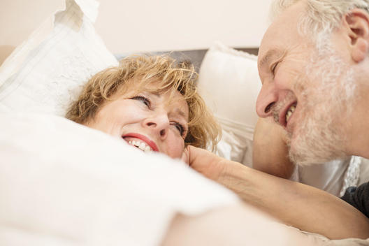 Couple in bed, smiling