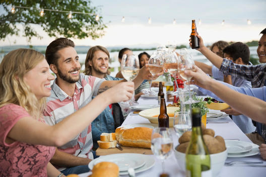 Group of friends toasting at an outdoor dinner party