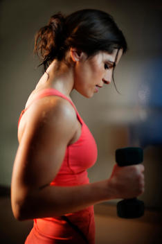 Sweaty Woman In Exercise Clothes Lifting Weights.