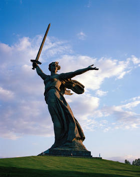 A Women Stands At The Base Of The Mamayev Monument Statue In Mamayev Kurgan In Volgograd.