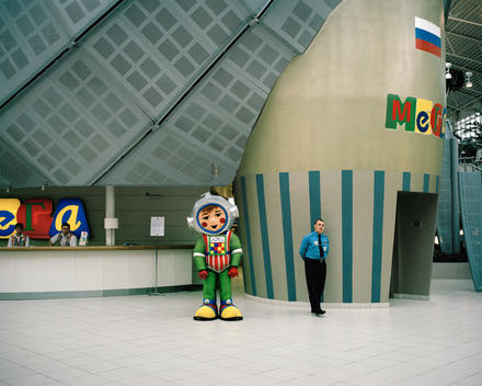 A Cartoon Mascot And Security Guard In The Mega Mall Shopping Center. Moscow, Russia