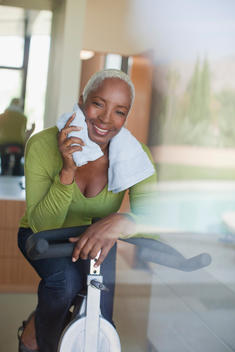 Older woman using exercise bike in home