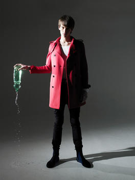 Fashion Story With A Male Model, Incorporating Lots Of Movement Model In Red Trench Coat Holding A Water Bottle Upside Down Thus Spilling Water