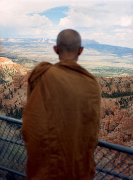 A Buddhist monk taking in the panoramic scenery reflects the spiritual beauty and warm earth colors of a view of Bryce Canyon in southwestern Utah.