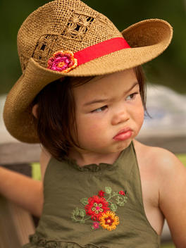 Young Girl In Cowgirl Hat Looking Off