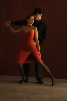 Couple tango dancing, holding hands, full length