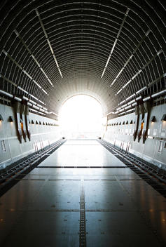 Inside an empty airplane, the end is opened revealing the outside
