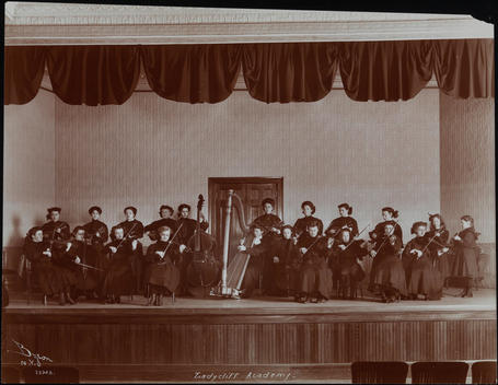 An All-Female String Ensemble Performing On An Auditorium Stage At The Ladycliff Academy On The Hudson River.