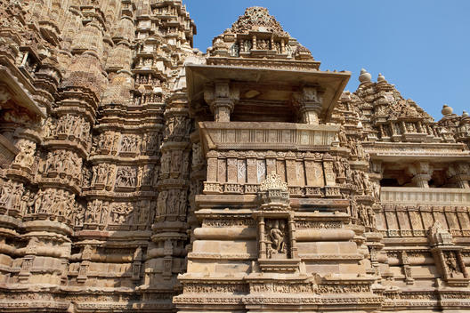 ancient stone carved Hindu temple at the Kama Sutra temple grounds of Khajuraho