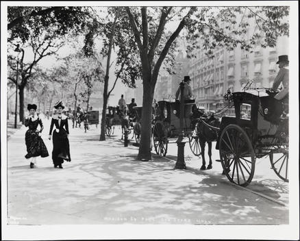 Two Women Walking North On Fifth Ave. Near The Park; Hansom Cabs Line The Street, Fifth Ave. Hotel Is In The Background.