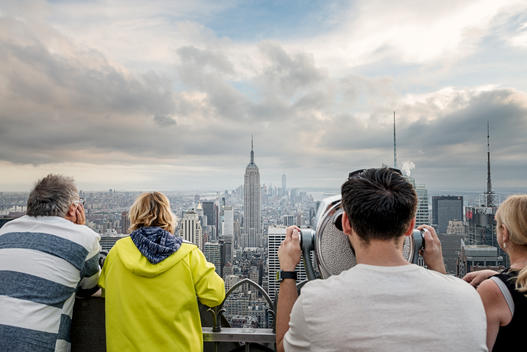 people on Top of the Rock platform facing the Empire State Building
