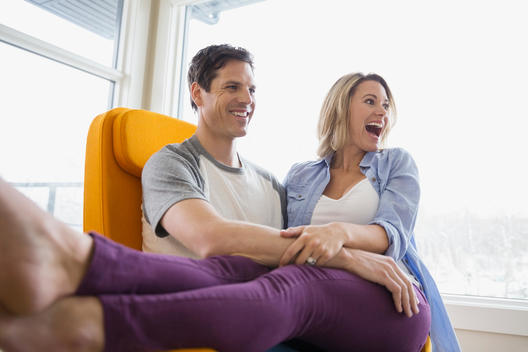 Enthusiastic couple in living room