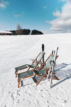 Germany, Bavaria, Winklmoosalm, Two deck chairs in the snow with skis