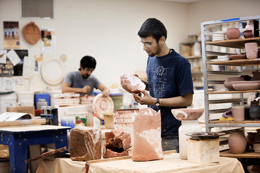 Indian man in pottery workshop